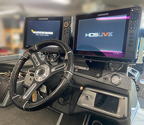 image of a boat install displaying two monitors and a steering wheel
